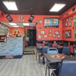 Interior of Guido's Steaks in Bensalem, PA, showing seating area and wall decorations