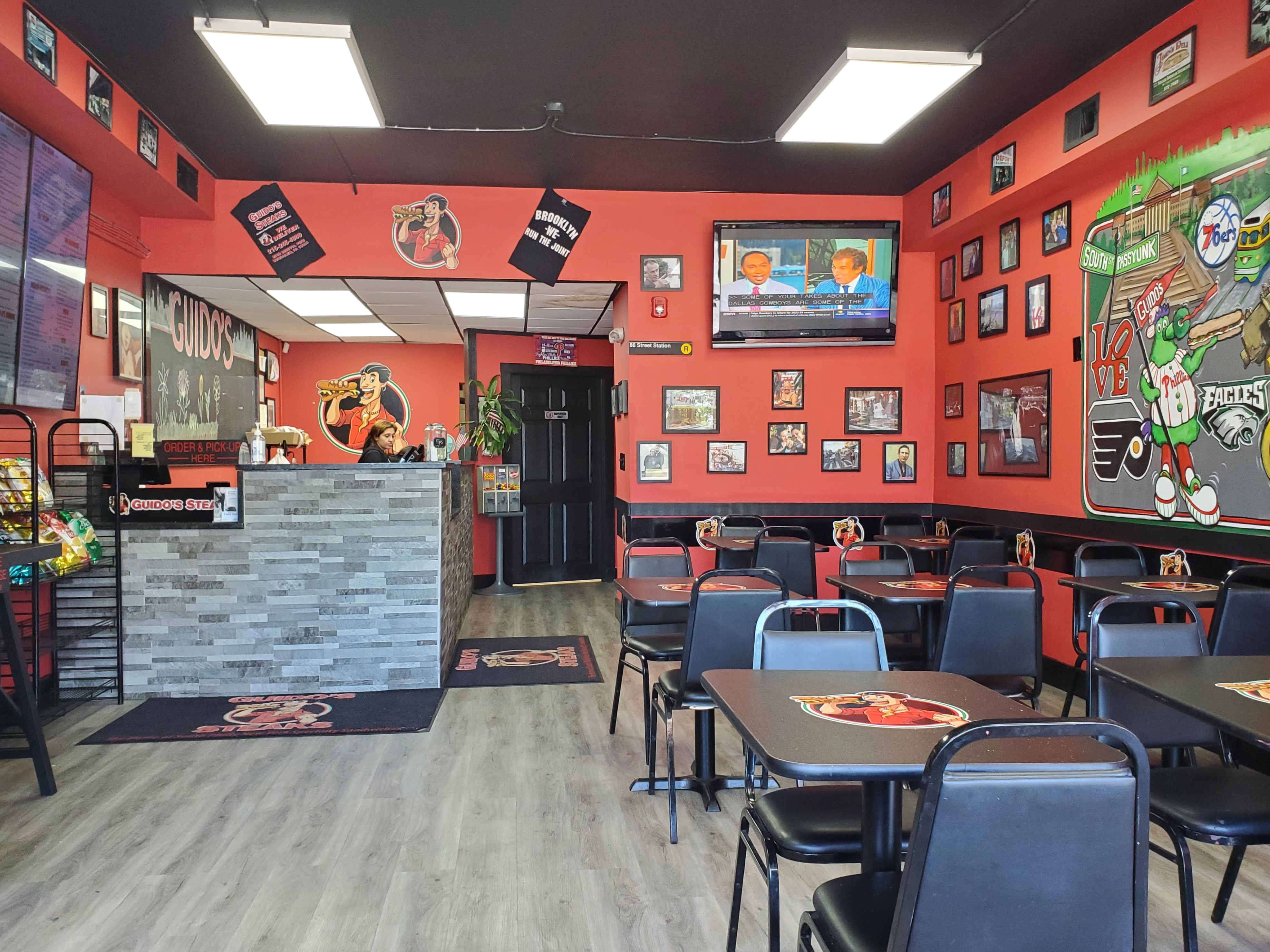 Interior of Guido's Steaks in Bensalem, PA, showing seating area and wall decorations