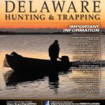 Cover of the 2024/2025 Delaware Hunting and Trapping Guide, showing a hunter on a small boat silhouetted against an orange sky