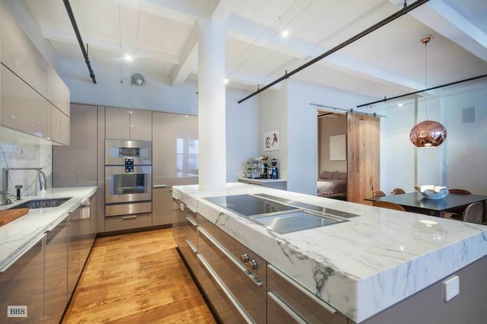 Chef Will Guidara's former Chelsea loft featured a custom kitchen designed by Poggenpohl and Gaggenau, reflecting his high standards and success in the culinary world.