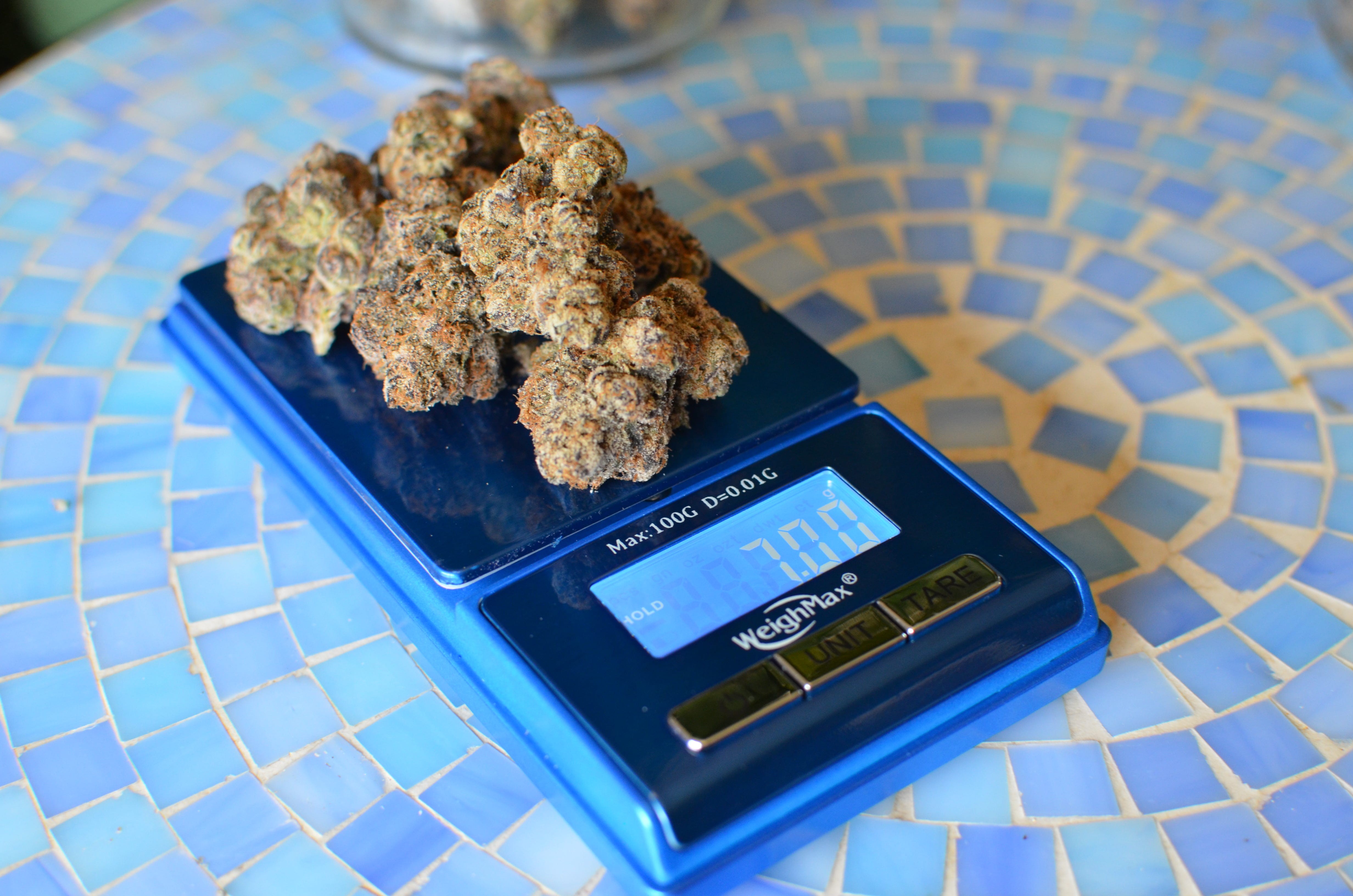 A quarter of cannabis flower, shown as a slightly larger pile of buds.