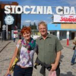 Rick Steves learns about Polish history at the Gdańsk Shipyard from a local guide, highlighting the value of local guides in understanding complex historical events.