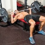 Performing the bench press exercise with proper form.