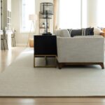 Elegant living room featuring a white rug that anchors the furniture and enhances the spacious feel.