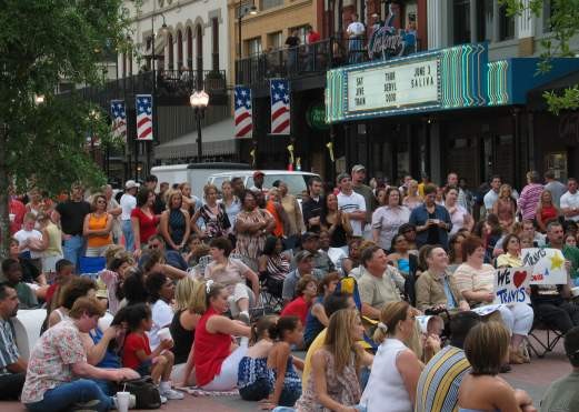 Crowd Of People Sitting In Front Of A Theatre