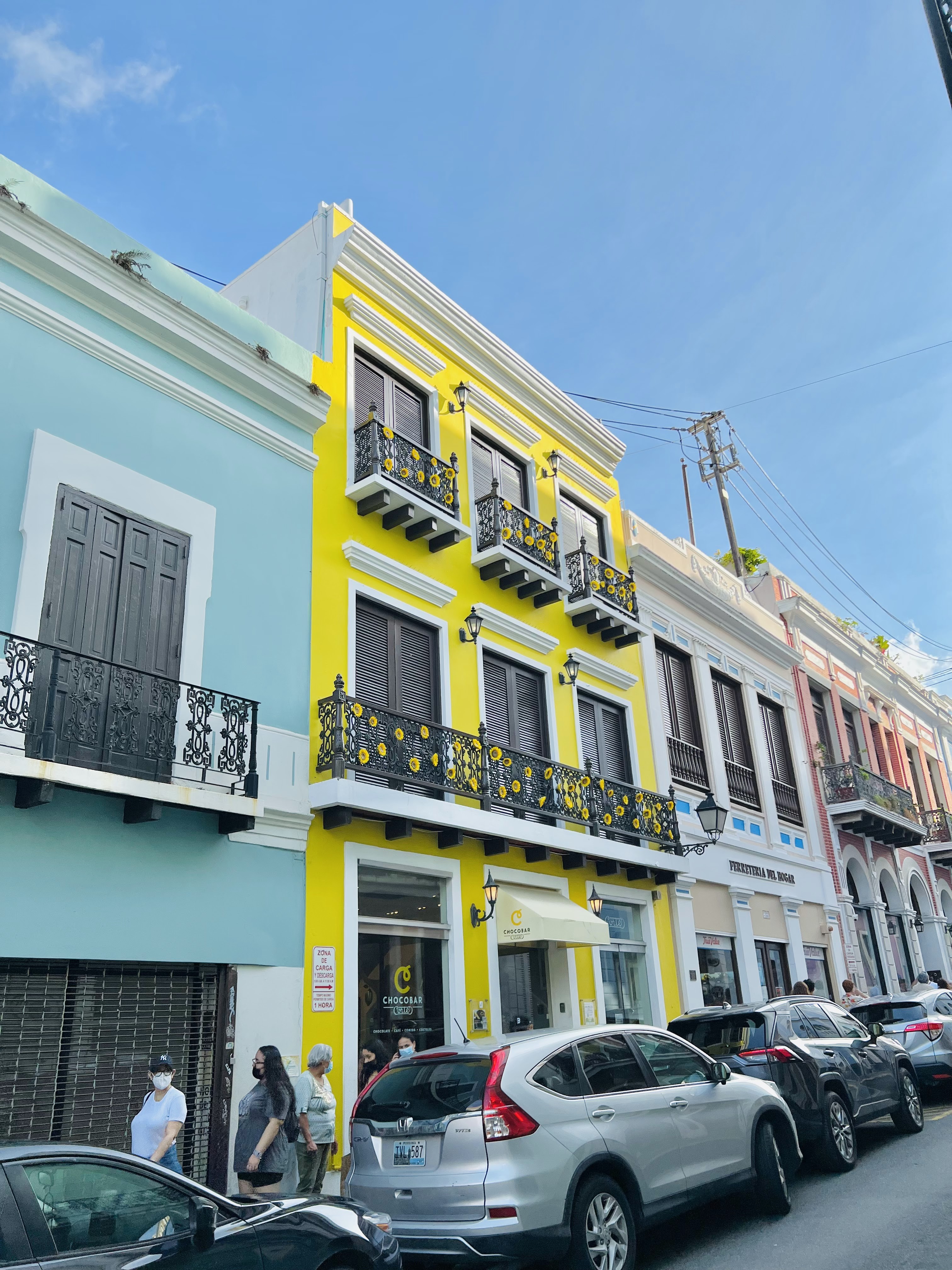 A vibrant street scene in Old San Juan, Puerto Rico, featuring colorful colonial buildings