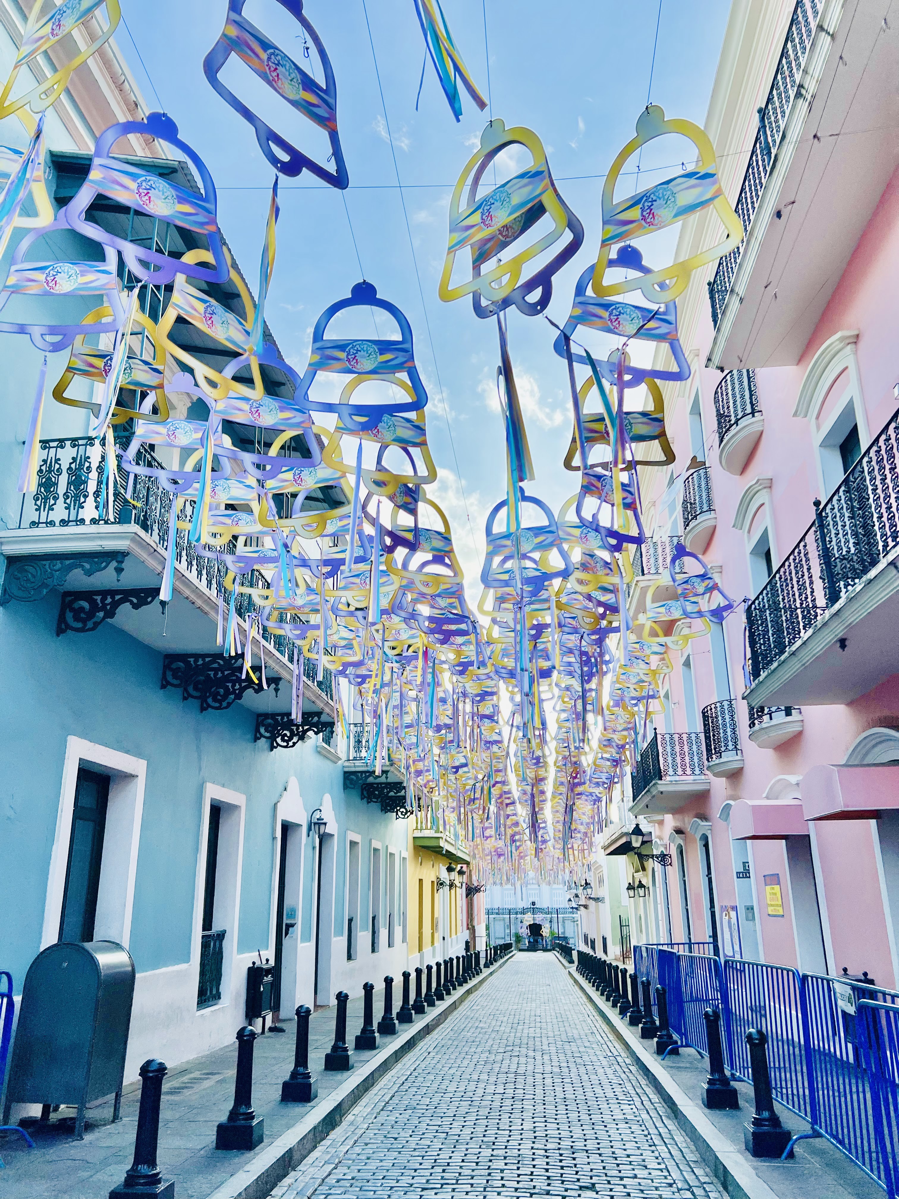 Calle de la Fortaleza in Old San Juan, Puerto Rico, adorned with colorful decorations overhead