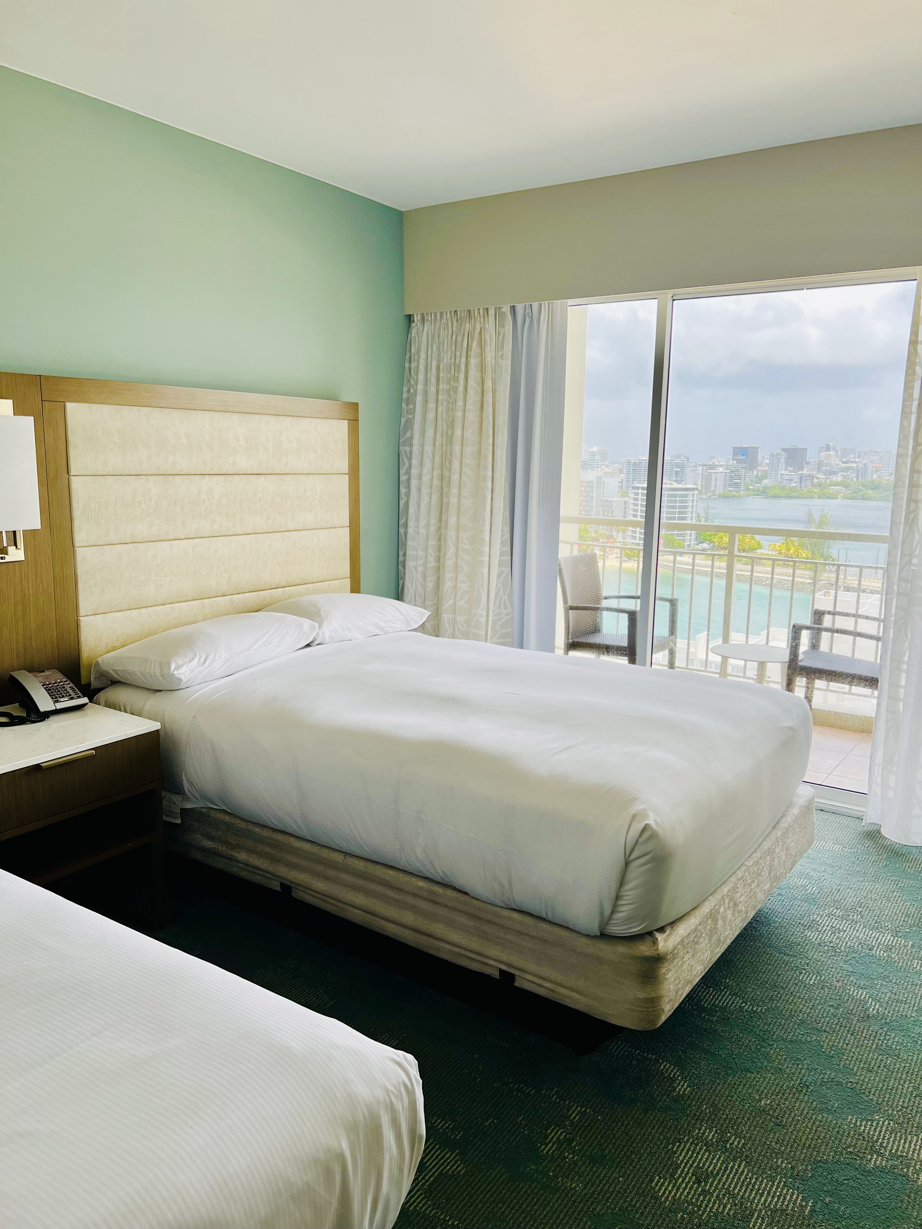 A spacious and well-lit hotel room at The Caribe Hilton in San Juan, Puerto Rico