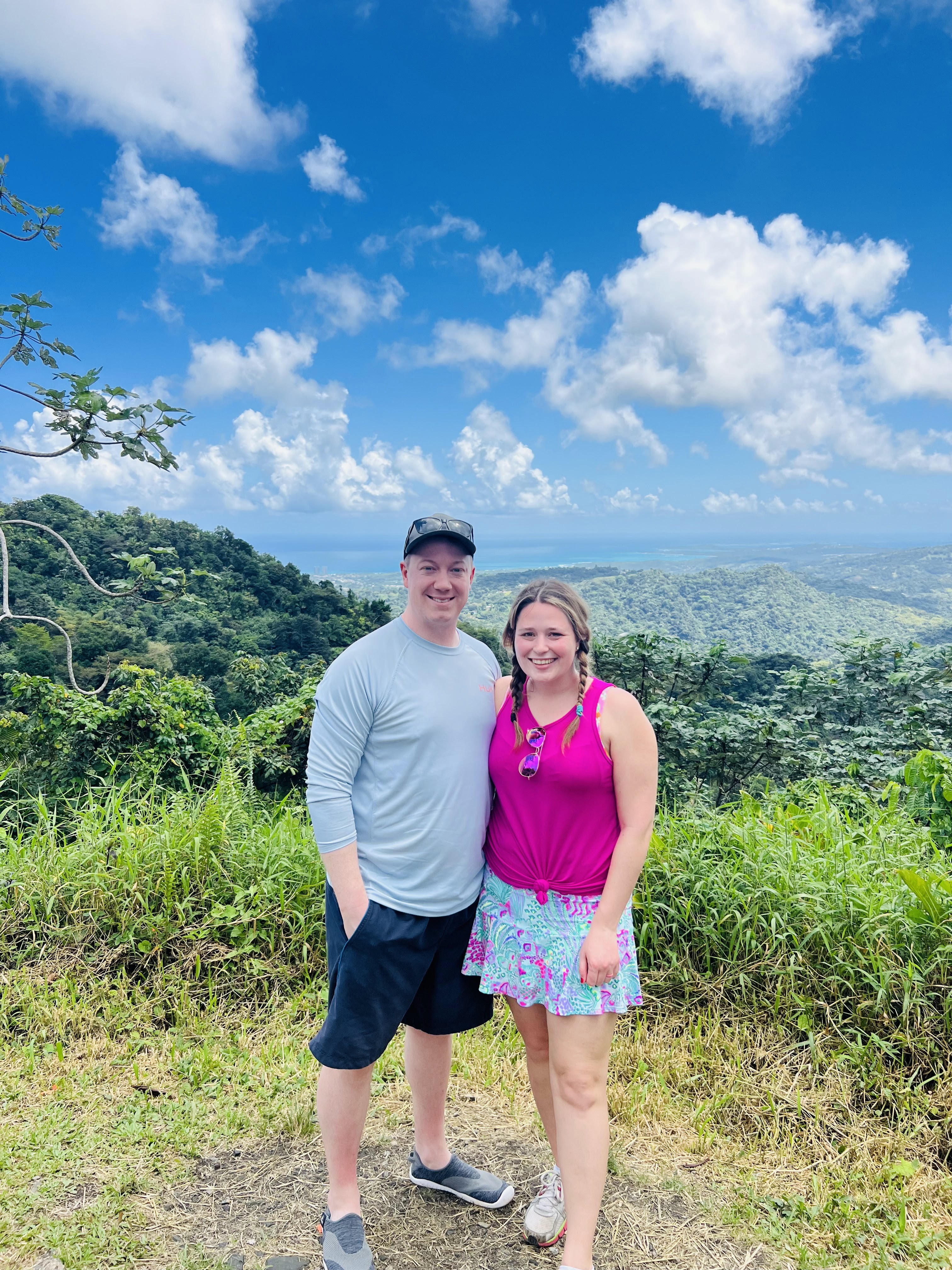 A group hiking through a trail in El Yunque National Forest, surrounded by dense rainforest