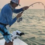 Angler proudly displays a sizable catch during a fishing trip.