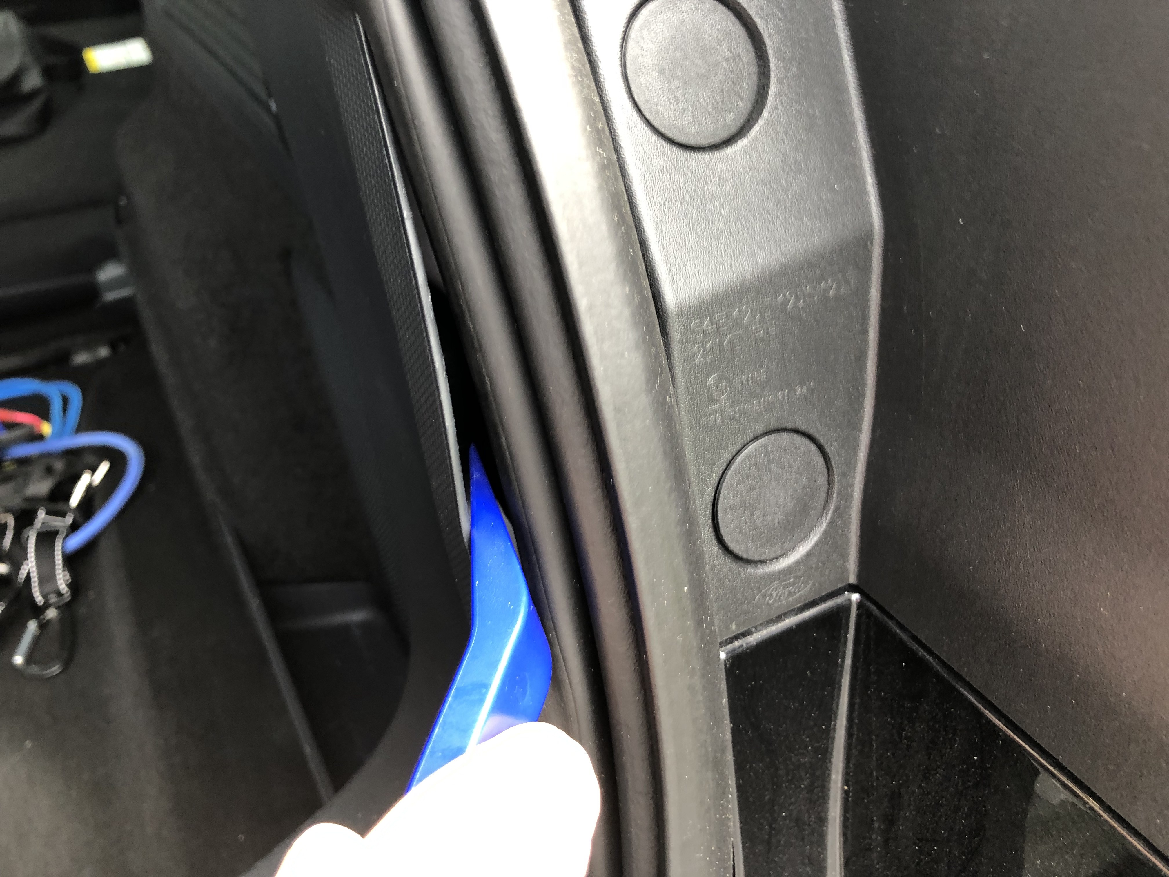 Prying the side panel from the car, past the rubber hatch seal