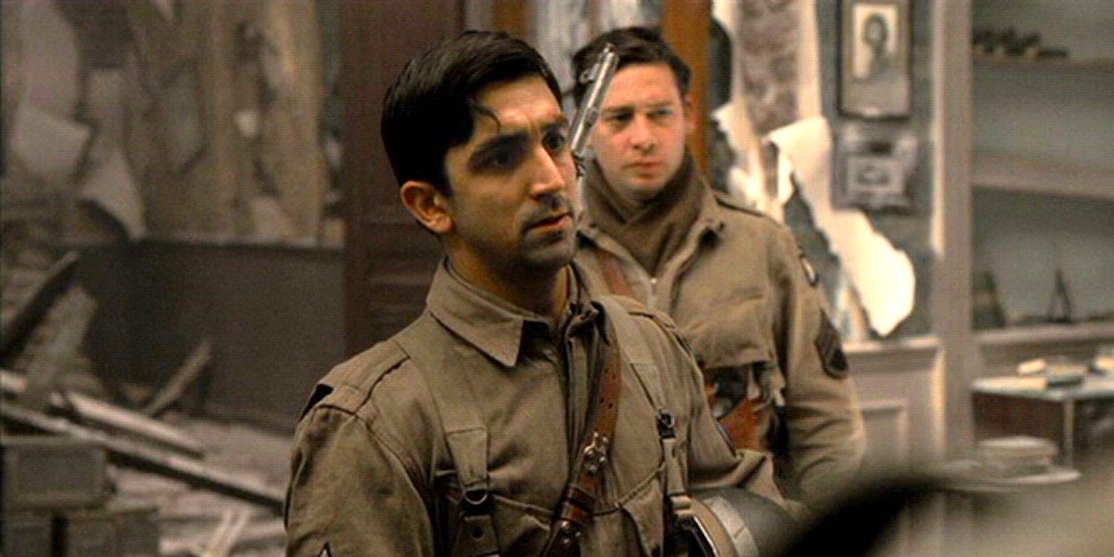 James Madio as Frank Perconte standing in a wartorn restaurant in Band of Brothers