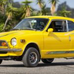 Front three-quarter view of a yellow 1972 Honda Z600 at Monterey Car Week auction, highlighting Hagerty Price Guide surprises.