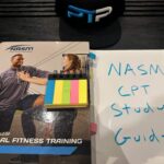 NASM CPT Study Guide - NASM Textbook on table with notes for studying the NASM personal trainer curriculum