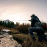 Fly fisherman wears Smith Guide