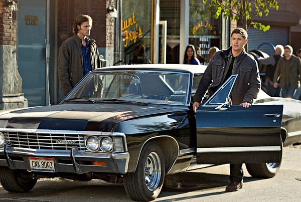 Supernatural Season 1 promotional image featuring the Impala and the Winchester brothers.