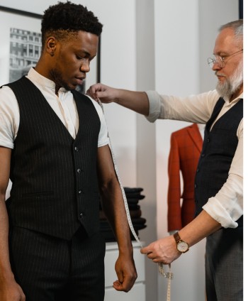 Measuring sleeve length for a men's dress shirt, extend the arm slightly and measure from the center back of neck to the wrist.