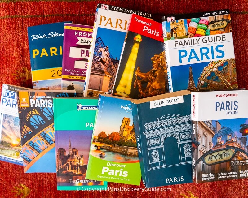 A collection of Paris travel guide books displayed in a bookstore, showcasing various titles and cover designs