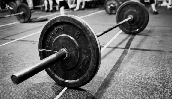 Barbells will be all over a CrossFit gym, symbolizing the emphasis on weightlifting and strength training in this fitness program