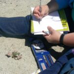 Field guide with a magnifying glass